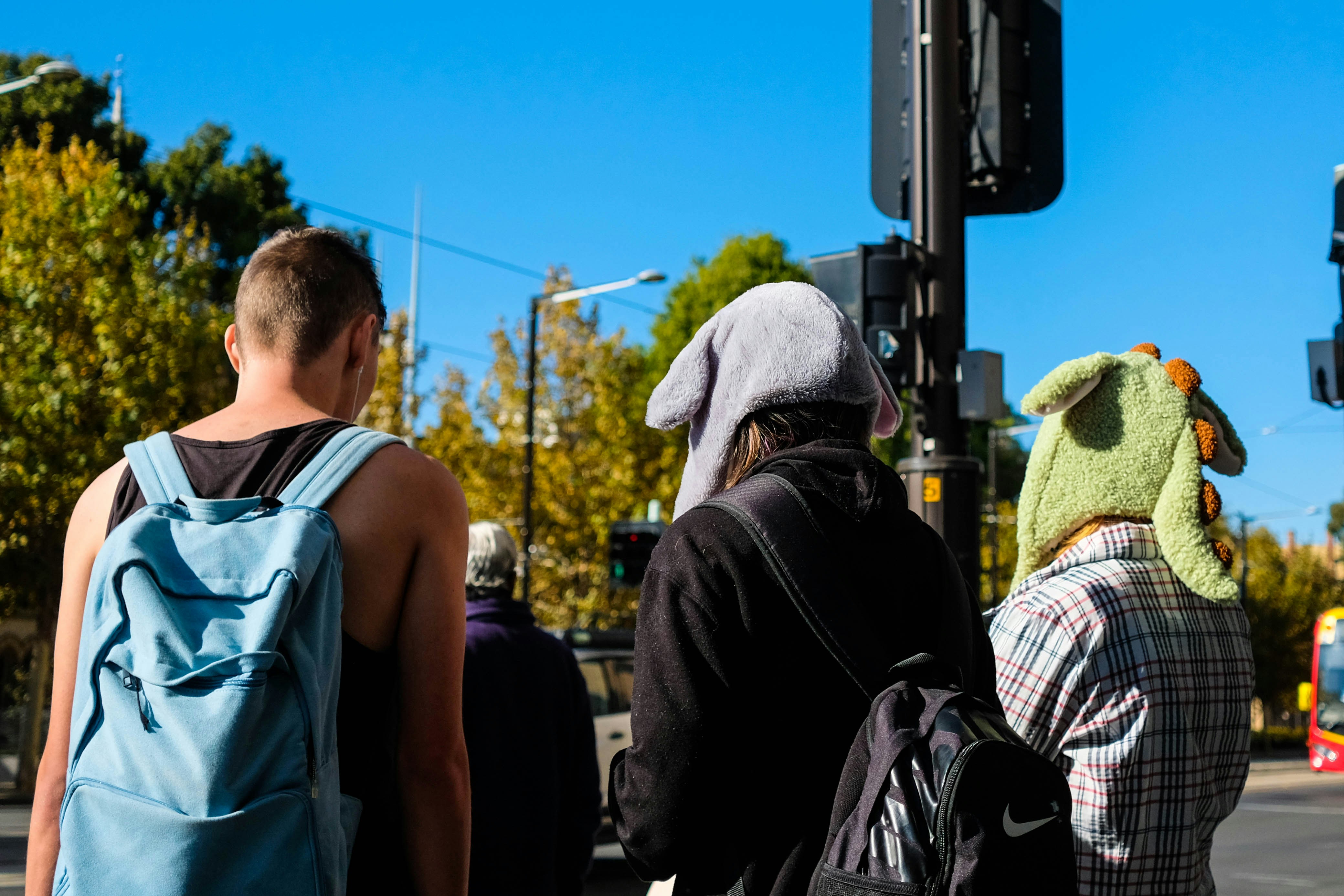 man in black backpack standing near man in white knit cap