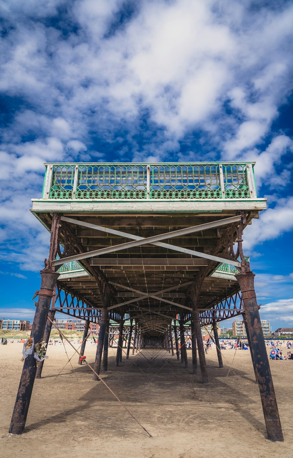 gray wooden bridge over the beach during daytime