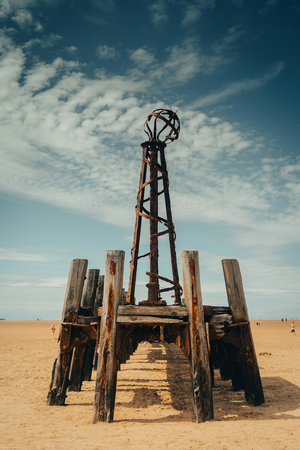 brown wooden tower on brown sand during daytime