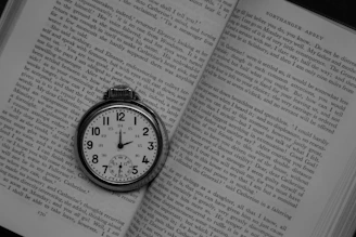 silver round analog watch at 10 10