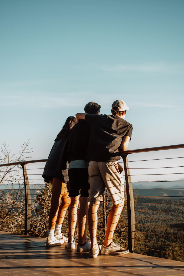 Two friends by the railings at sunset