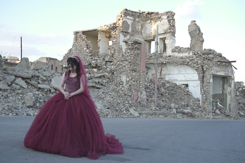 woman in pink dress standing on gray concrete floor