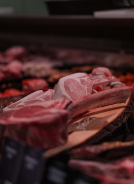 raw meat on brown wooden tray