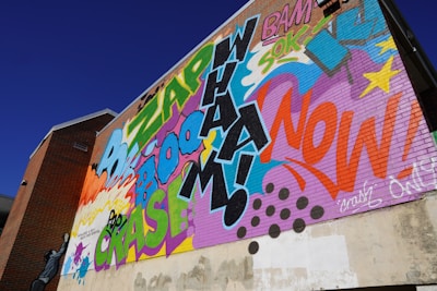 Vibrant street art featuring the words 'Boom Warrior' integrated with urban, edgy designs and bursts of color.