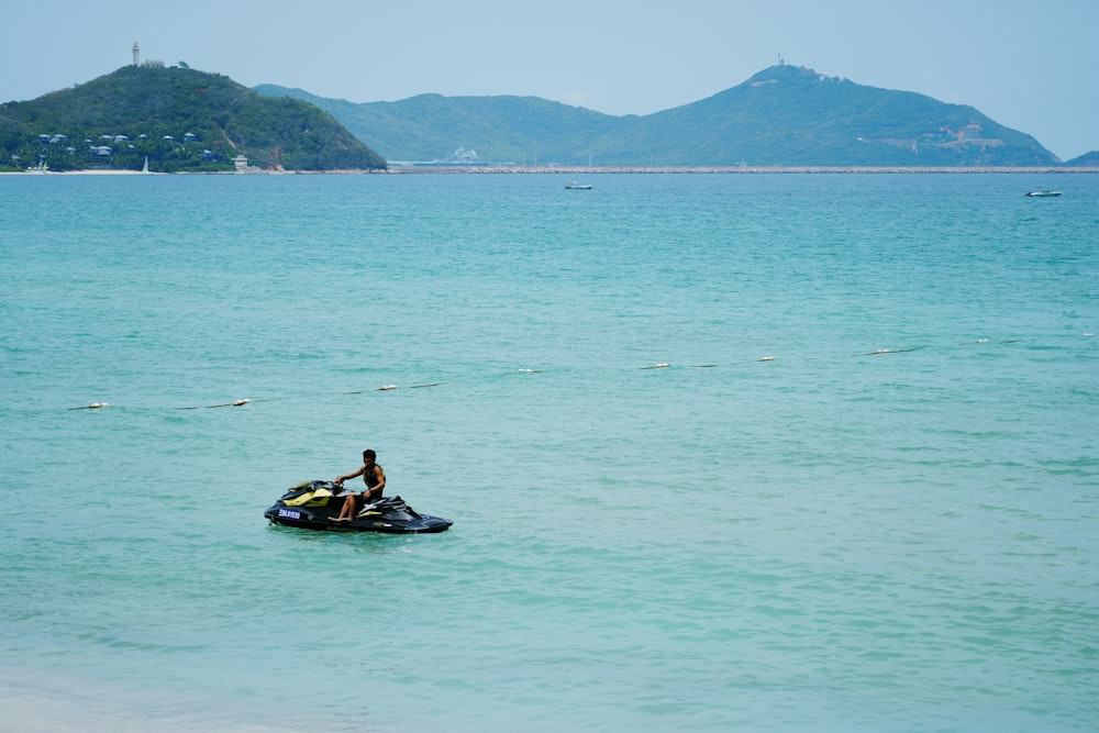 man in yellow shirt riding on yellow kayak on sea during daytime