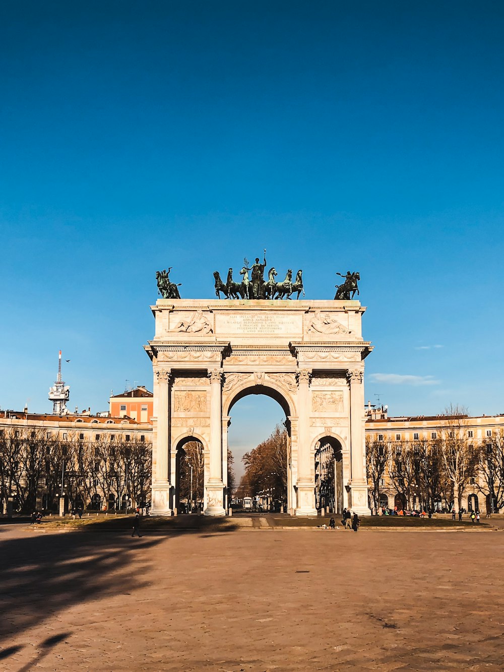 white concrete arch under blue sky during daytime