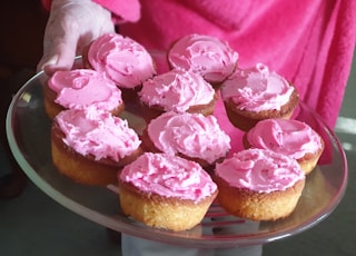 pink and brown cupcakes on brown tray