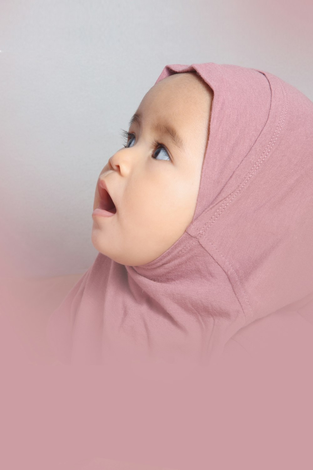 baby in pink hijab and pink shirt