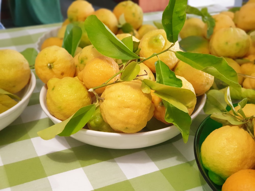 yellow citrus fruits on white ceramic plate