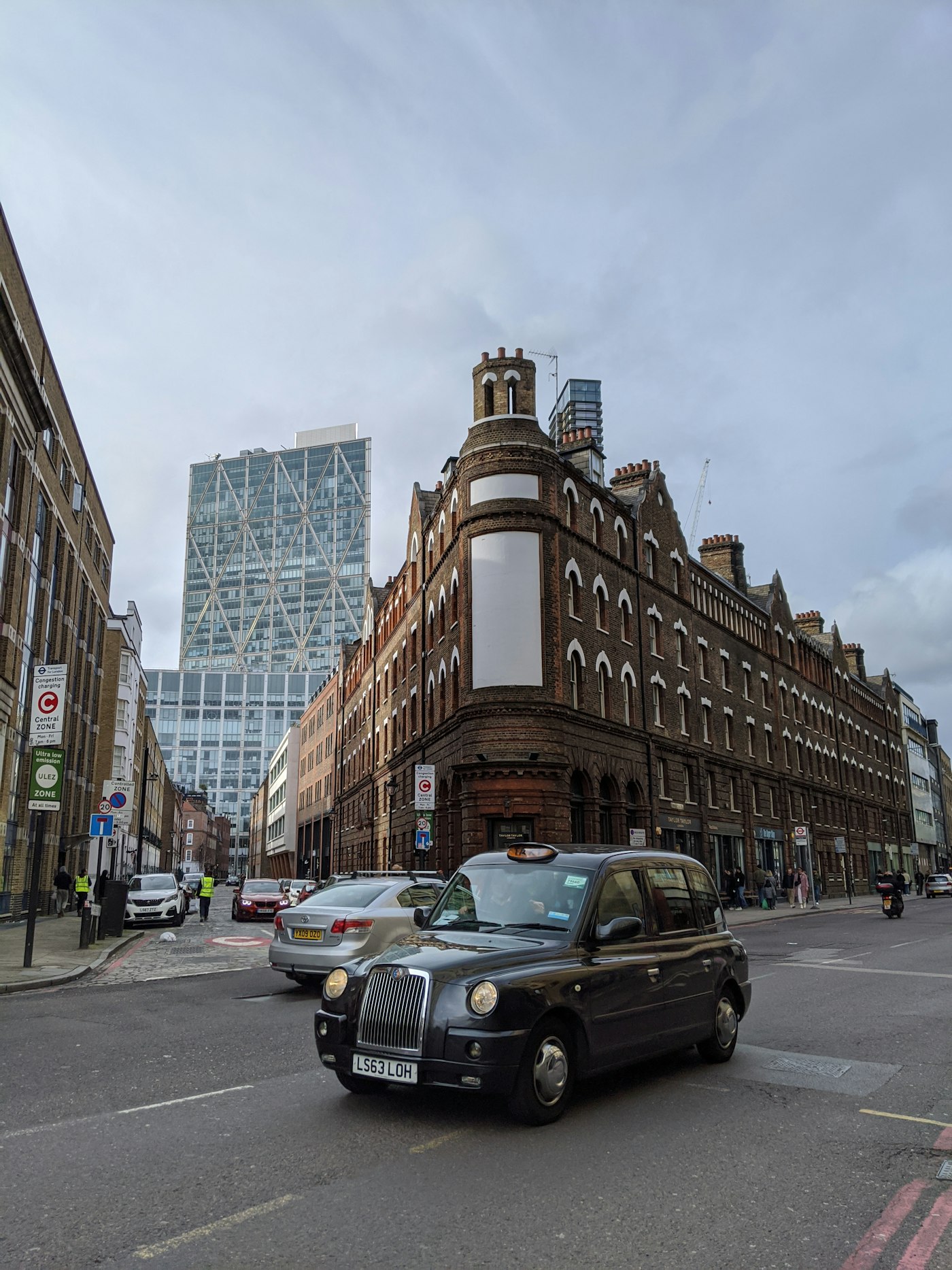 Black taxi moving along a London street