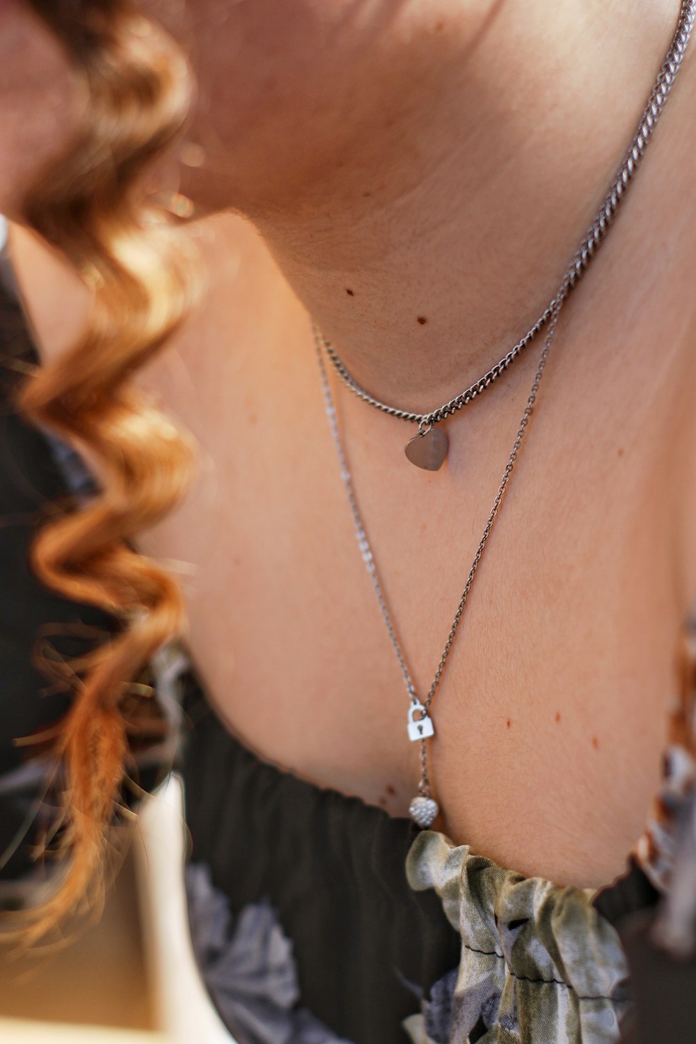 woman wearing silver necklace and white shirt