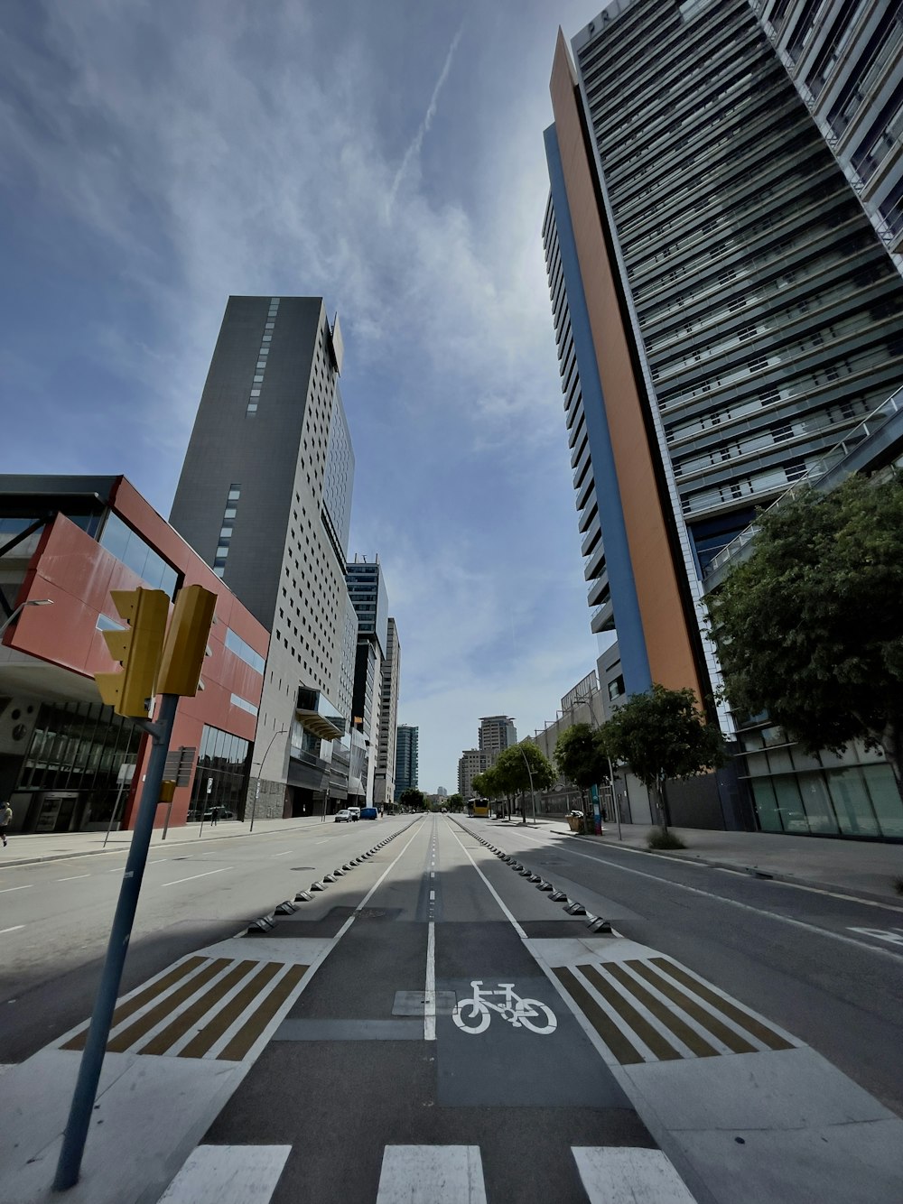 gray concrete road between high rise buildings during daytime