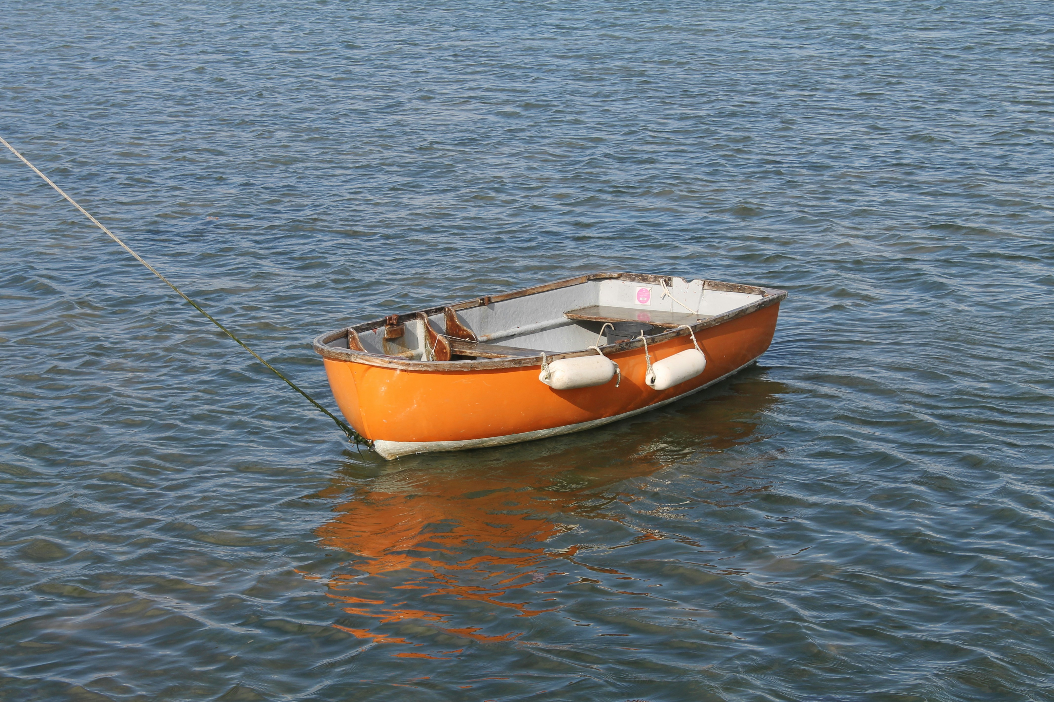 Orange rowing boat on the open water in Isle of Wight