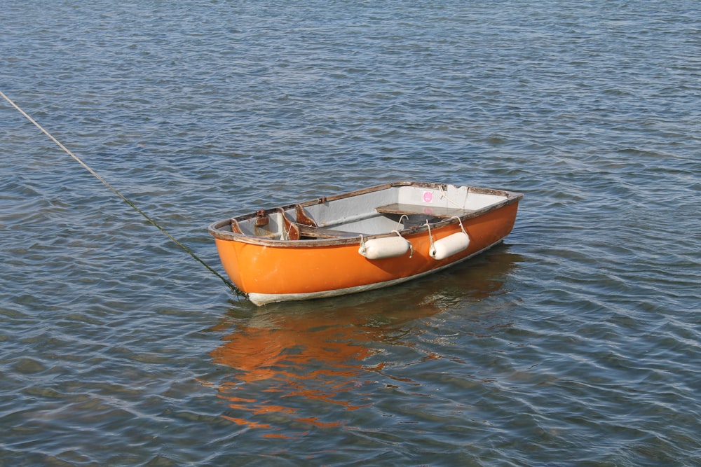 brown and white boat on body of water during daytime