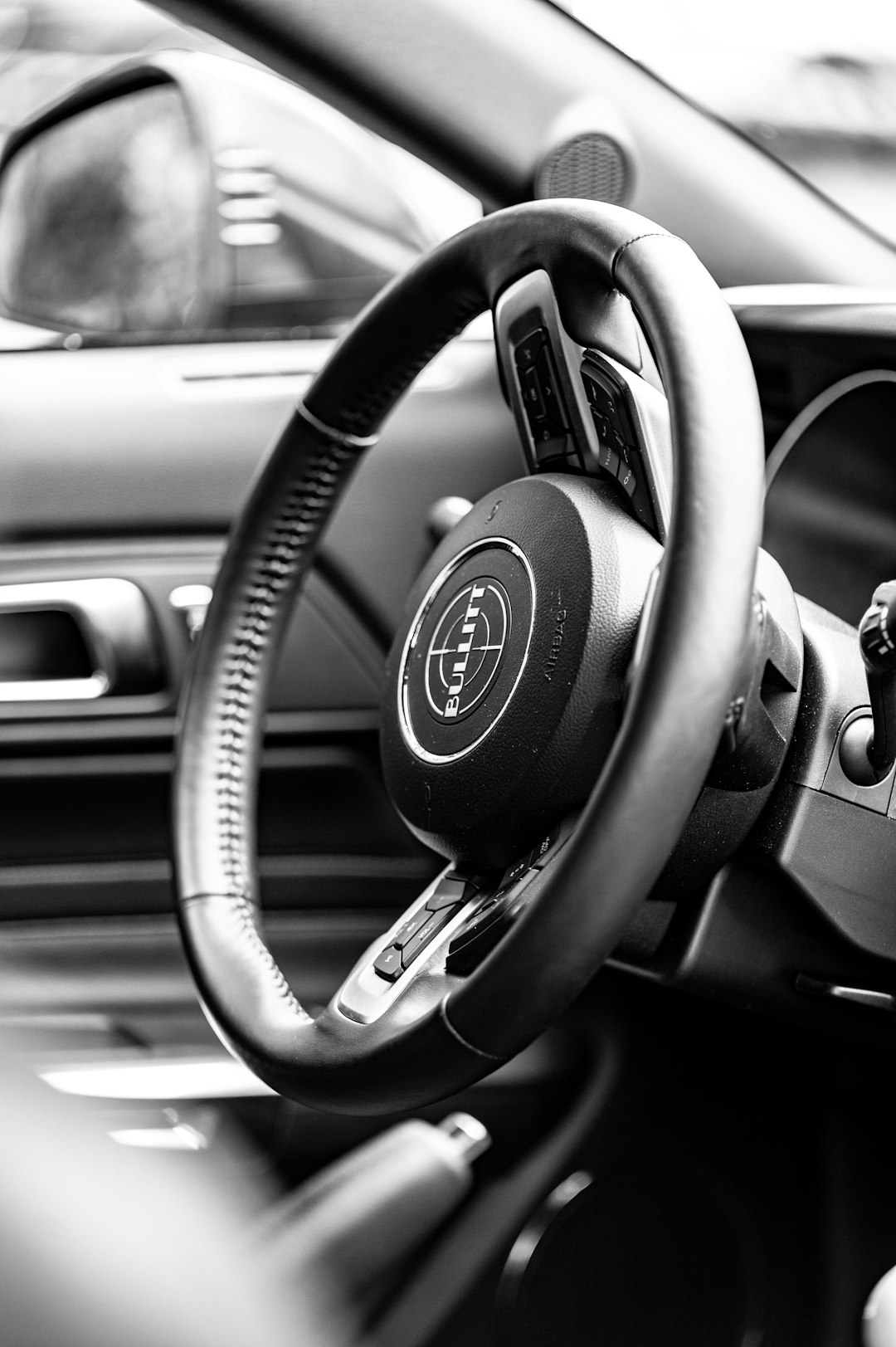 black and gray nissan steering wheel