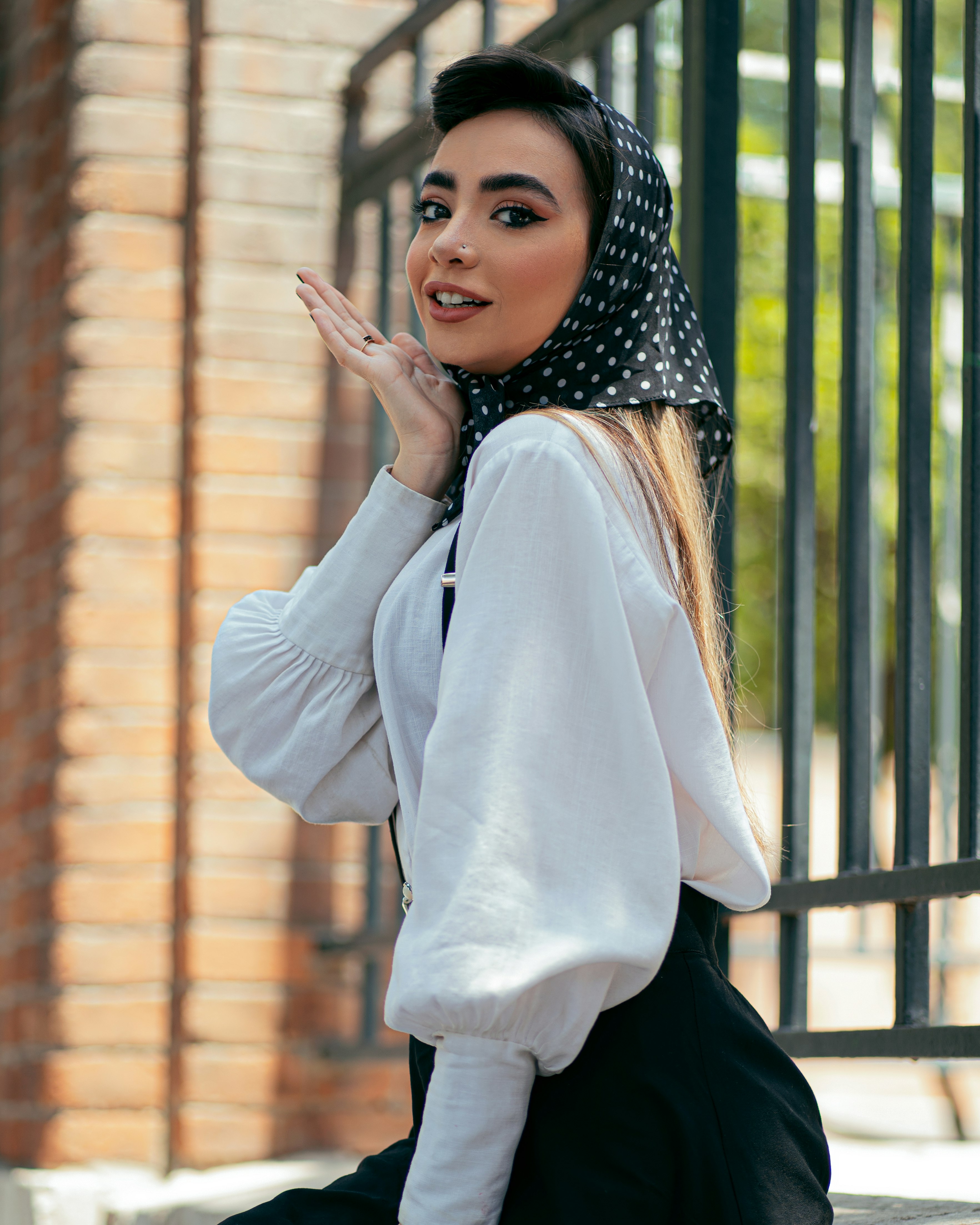 woman in white long sleeve shirt and black pants