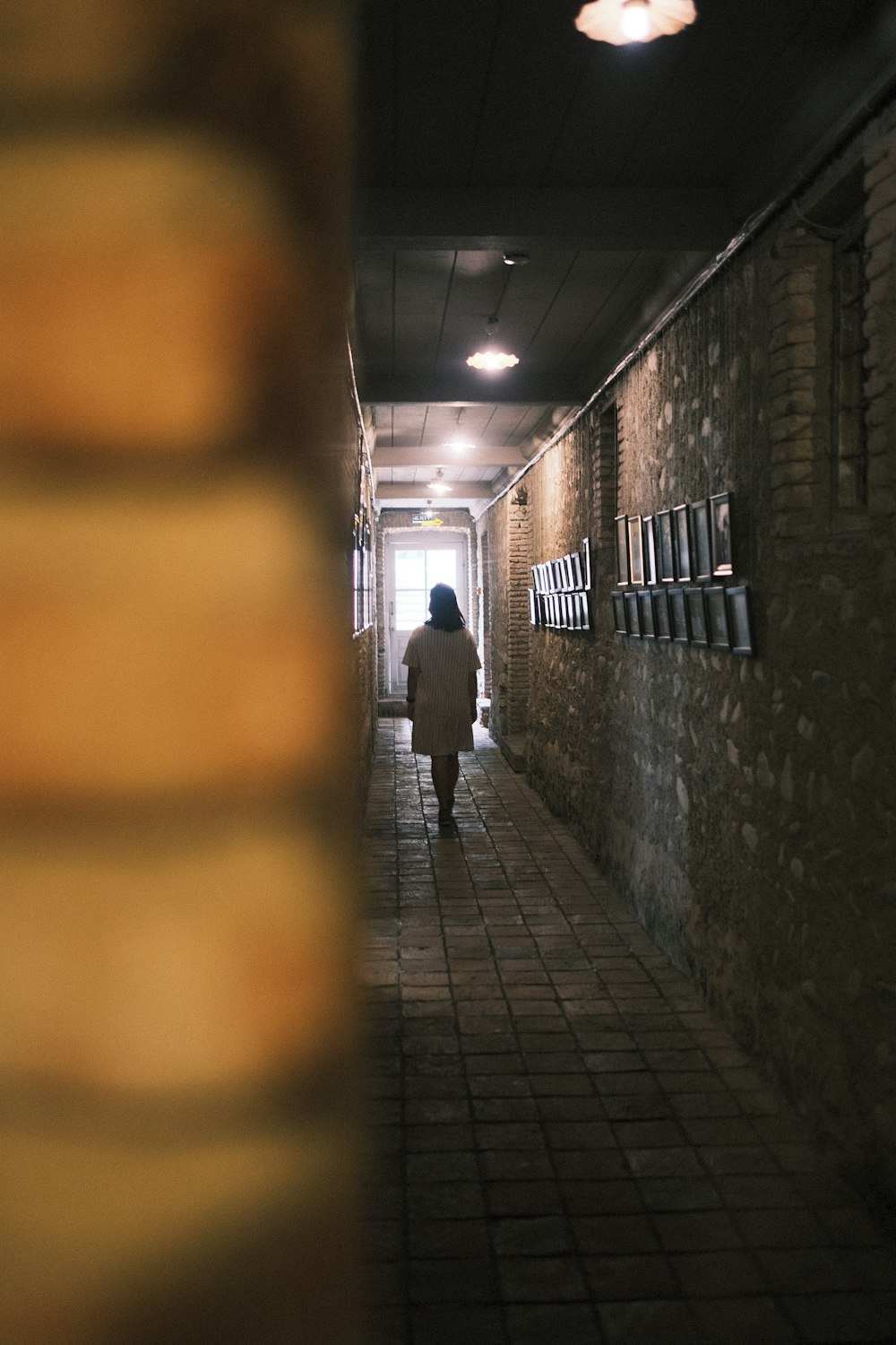 man in black jacket walking on hallway