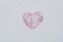 pink heart shaped balloon on white textile