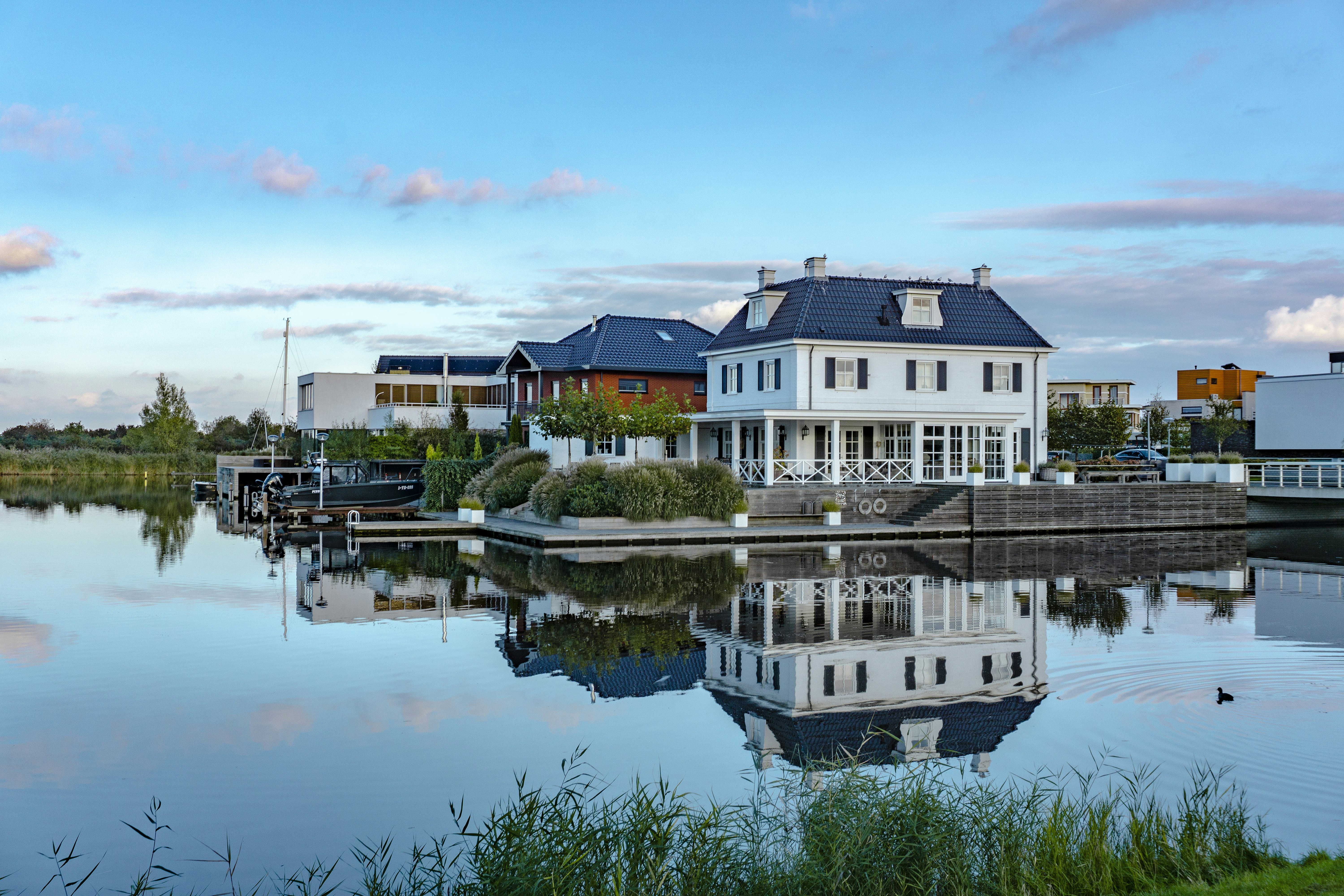 white and brown concrete building beside body of water during daytime