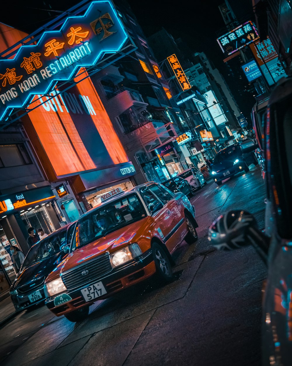 red car on the street during night time