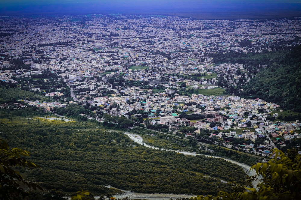 aerial view of city buildings and green grass field during daytime