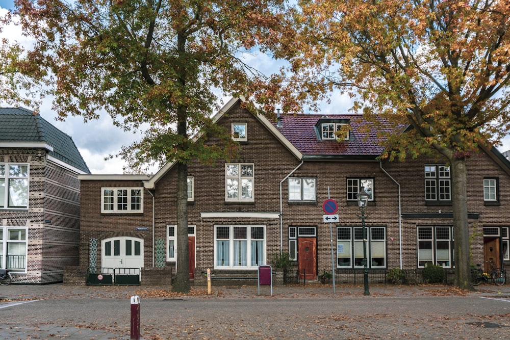 brown and white concrete house near trees during daytime