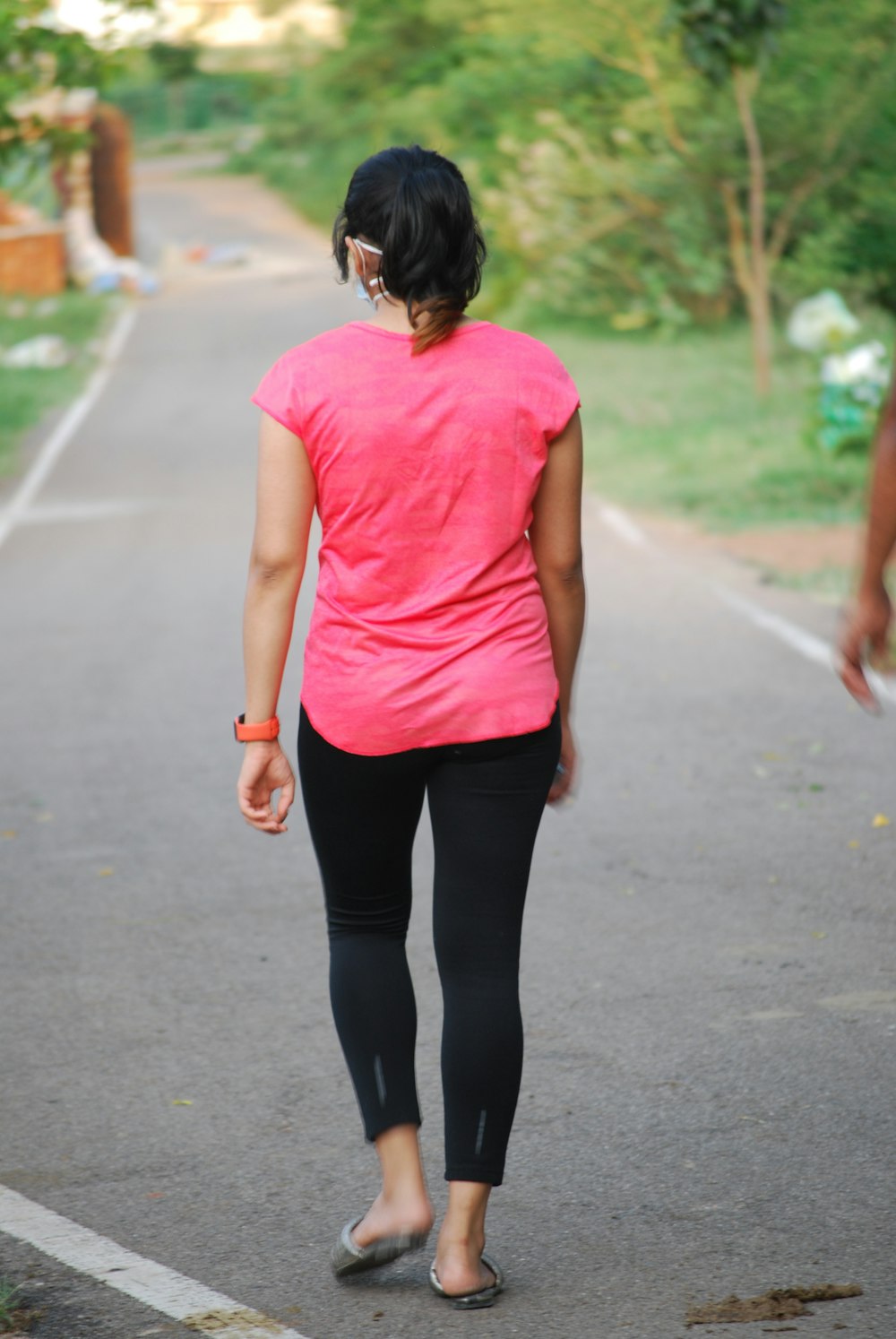 woman in red tank top and black leggings walking on road during daytime  photo – Free Person Image on Unsplash
