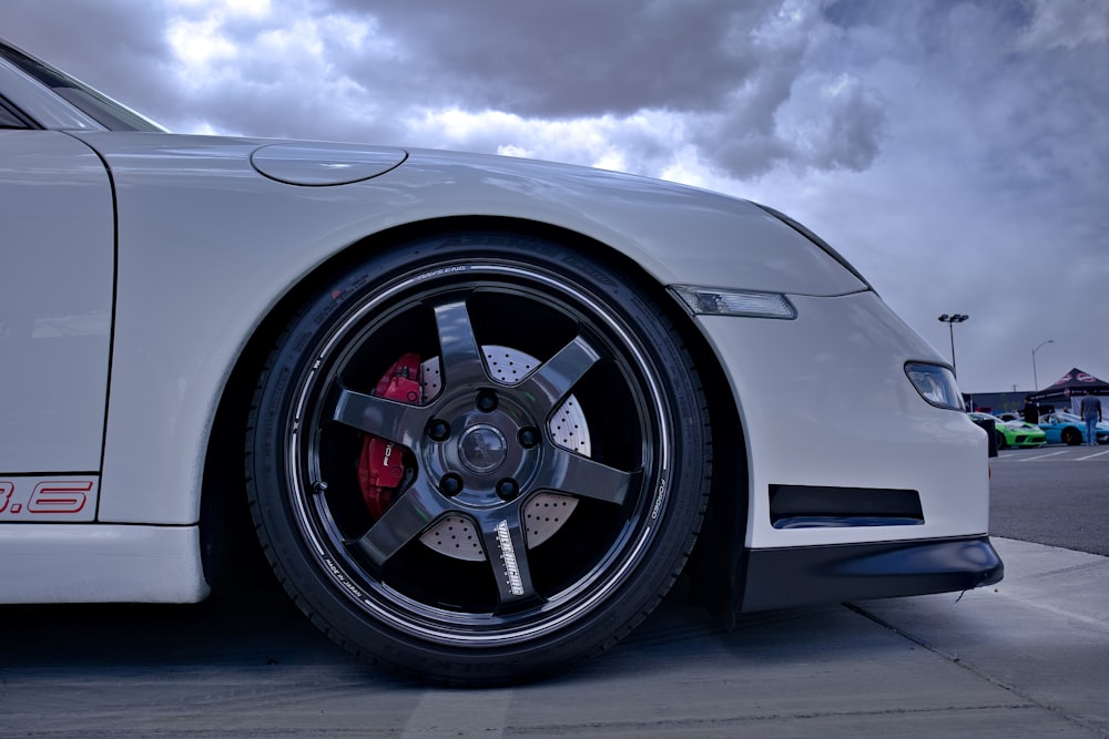 a white sports car parked on the side of the road