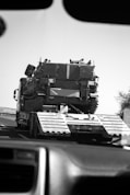 a large military vehicle driving down a highway