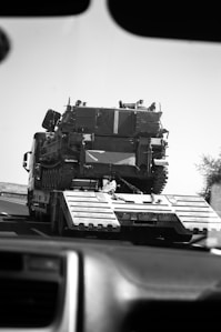 a large military vehicle driving down a highway