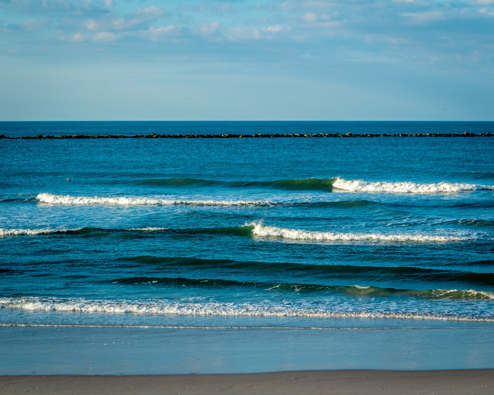 a body of water with waves coming in to shore