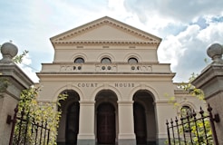 a large white building with a gate in front of it