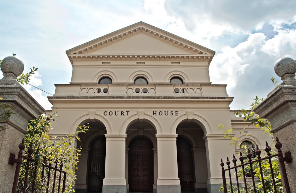 a large white building with a gate in front of it