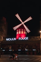 red and white windmill during night time