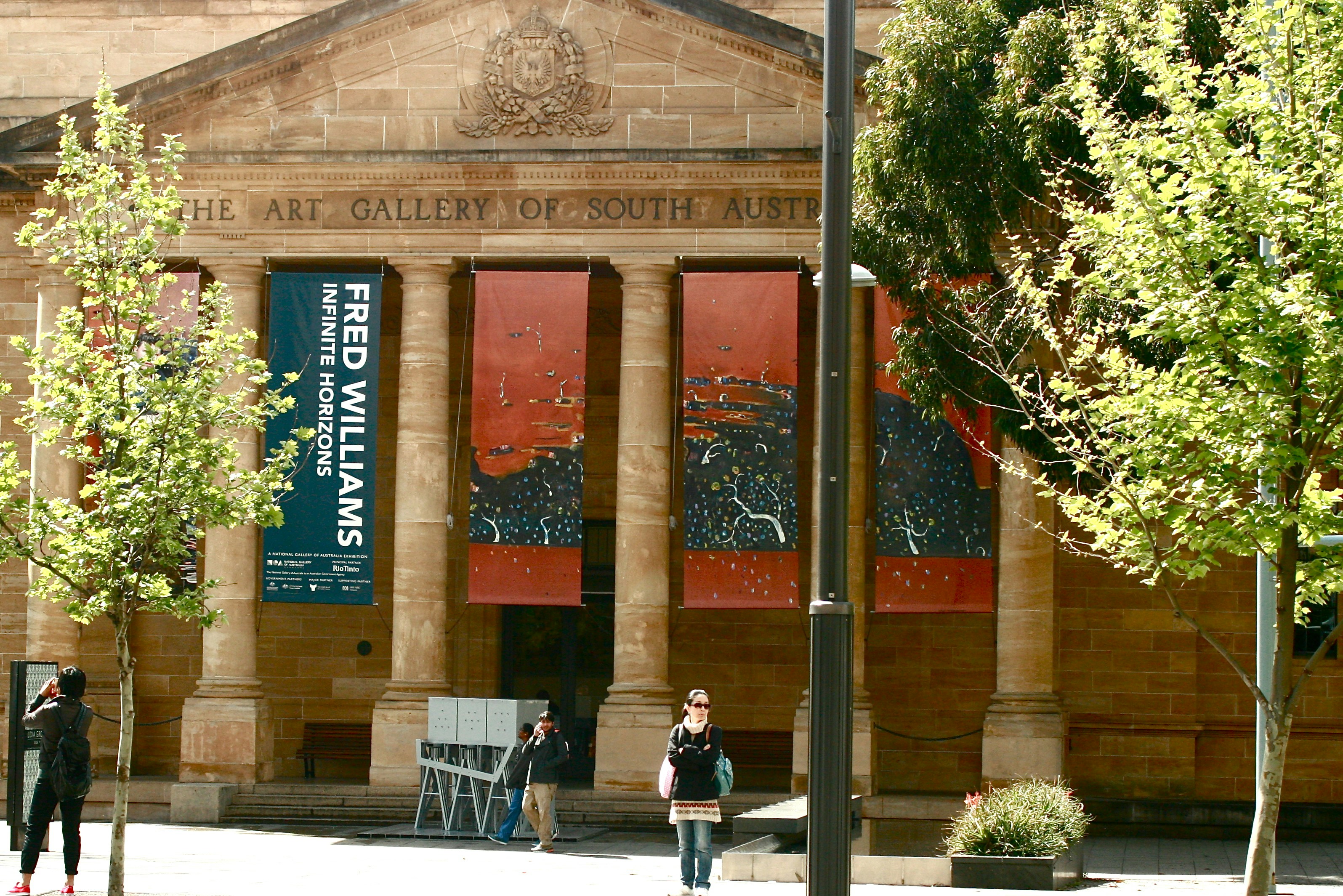 a couple of people standing outside of a building