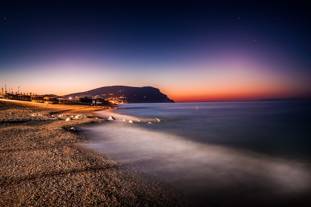 a long exposure photo of a beach at night