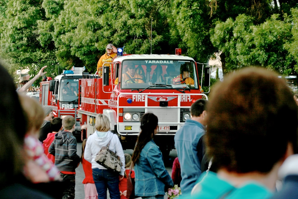 a group of people standing around a fire truck
