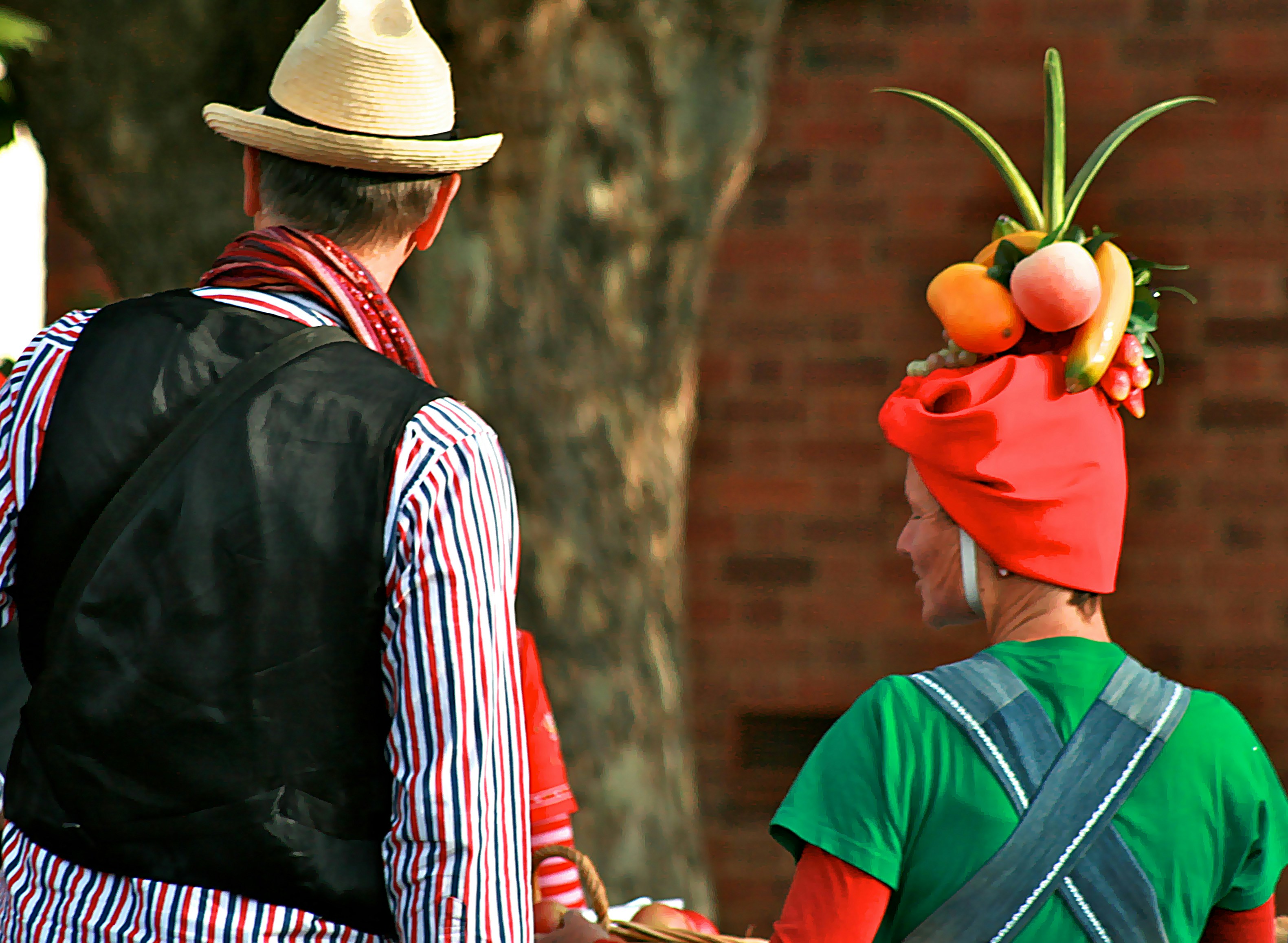 man in red hat holding apple fruit