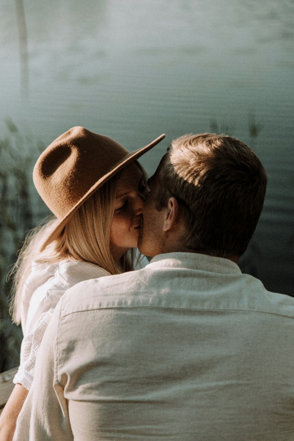 man and woman kissing during daytime