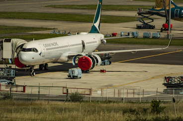 white and blue passenger plane on airport during daytime