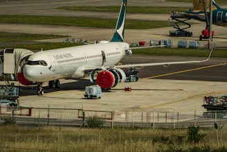 white and blue passenger plane on airport during daytime