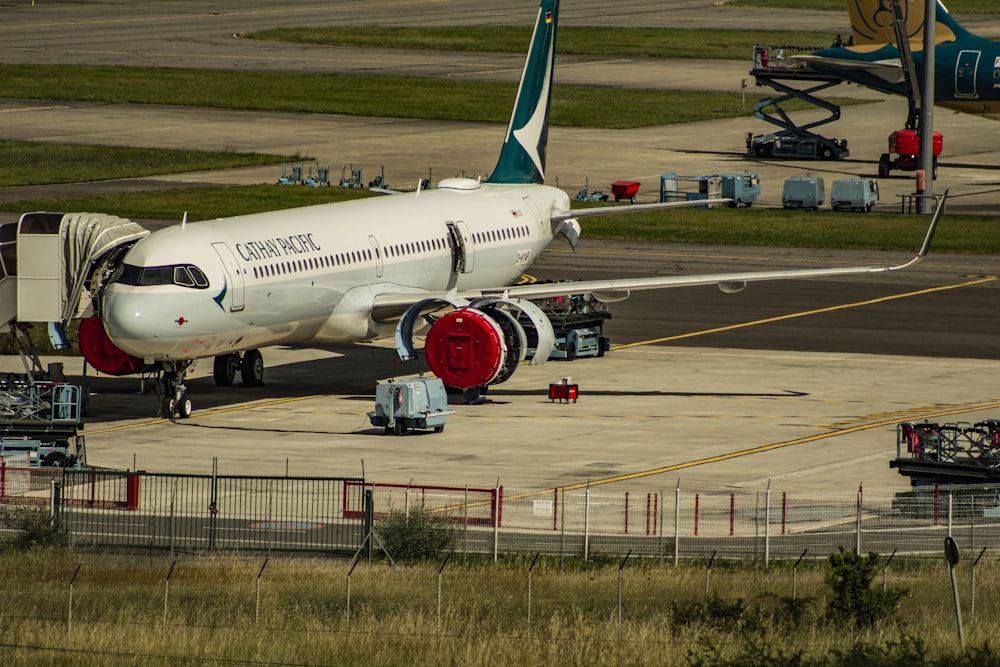 white and blue passenger plane on airport during daytime