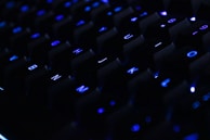 a close up of a computer keyboard in the dark