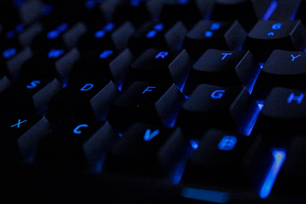 a close up of a keyboard with blue keys