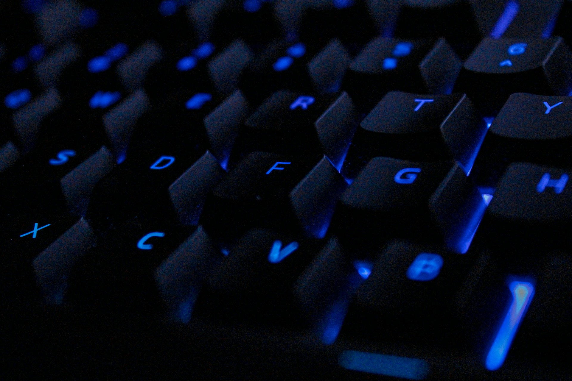 a close up of a keyboard with blue keys