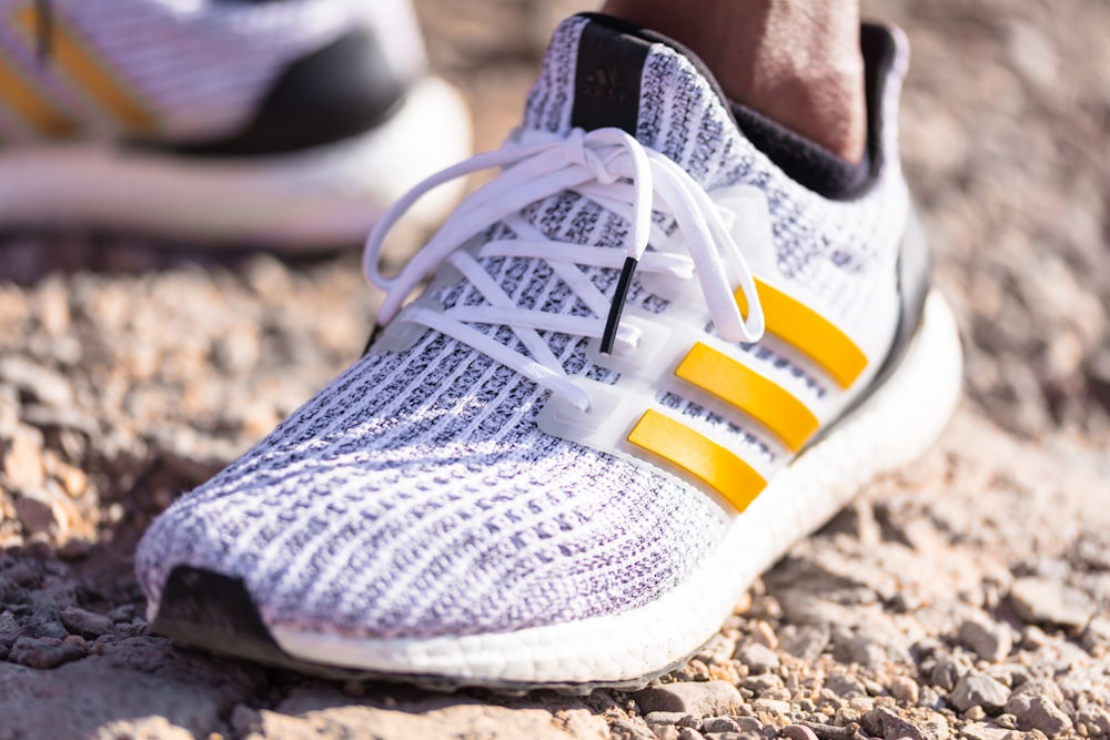gray and yellow adidas athletic shoes
