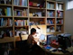 woman in black shirt sitting on chair in front of table