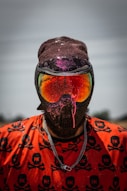person in red and black mask and orange shirt