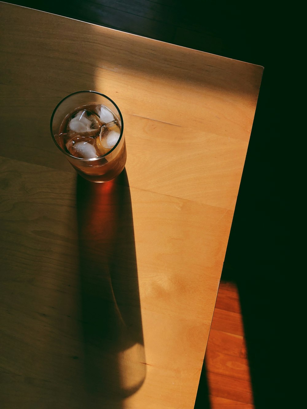 stainless steel vacuum flask on brown wooden table