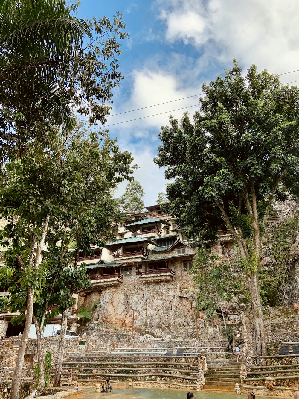 green trees near brown rock formation during daytime